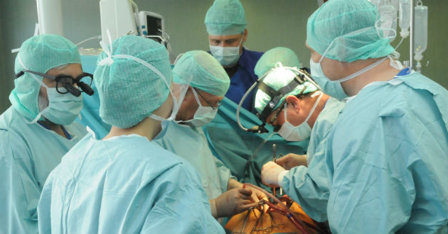 Surgeons operate on a patient.