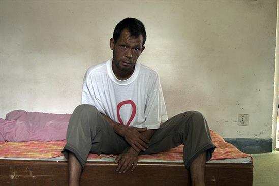 A man sitting on his bed in Nepal
