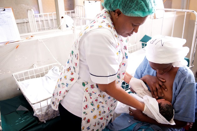midwife-breastfeeding.jpg A midwife helps a mother with breastfeeding at a hospital