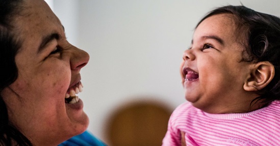 A mother shares a laugh with her child.