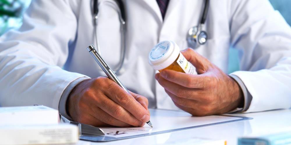 pharmacist-prescription-medicine Doctor writing out prescription.