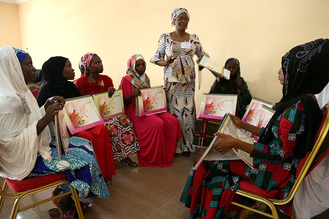 A group of women taking part in a community resource training on how to prevent and treat illness in children through such actions as hand washing, breast feeding and malnutrition screening, Borno State, Nigeria 2016.