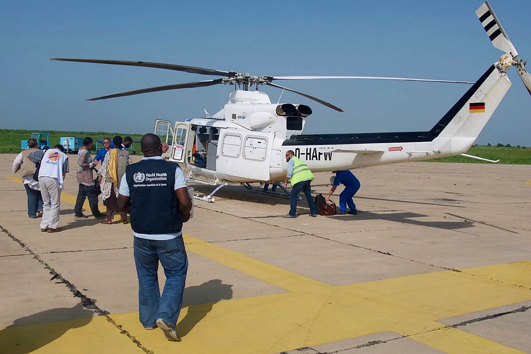 Dr Ifeanyi Okudo, Public Health Officer with WHO Nigeria, prepares to board a United Nations Humanitarian Air Service helicopter for the short flight from Maiduguri to Monguno. Nigeria 2016.