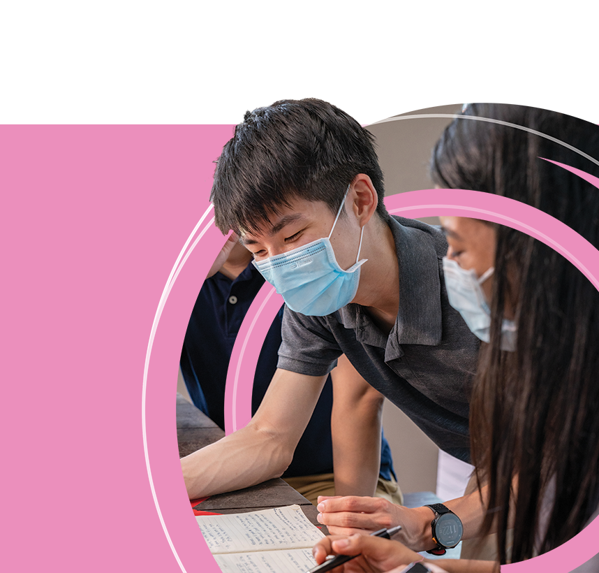 Chap5-Main-img Two young people wearing masks reading a paper