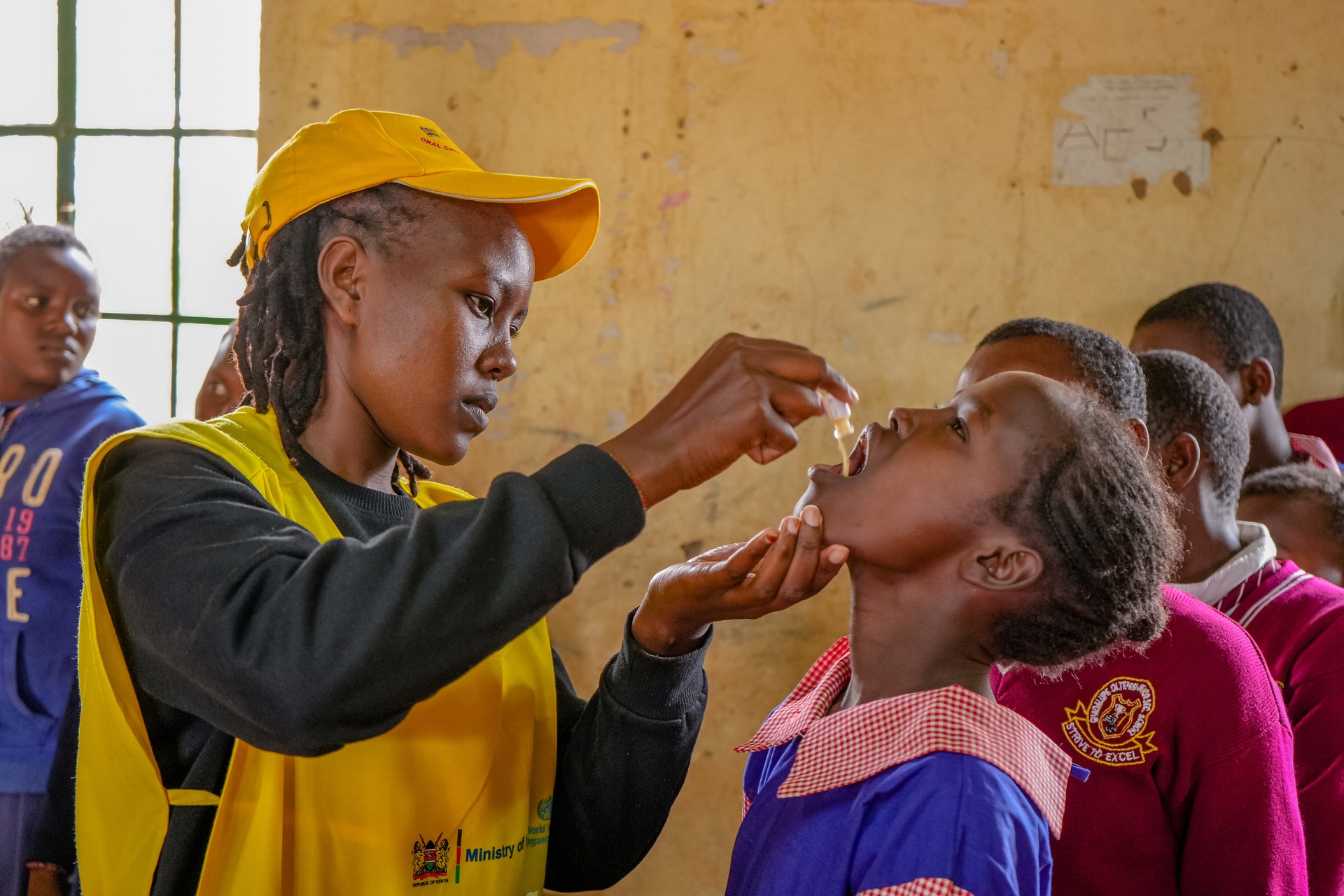 Oral cholera vaccination Kenya A vaccinator from Mashuuru, administers oral cholera vaccine (OCV) to a student in Guadalupe Oltepesi Primary School during the OCV campaign in Kajiado on 4 August 2023.