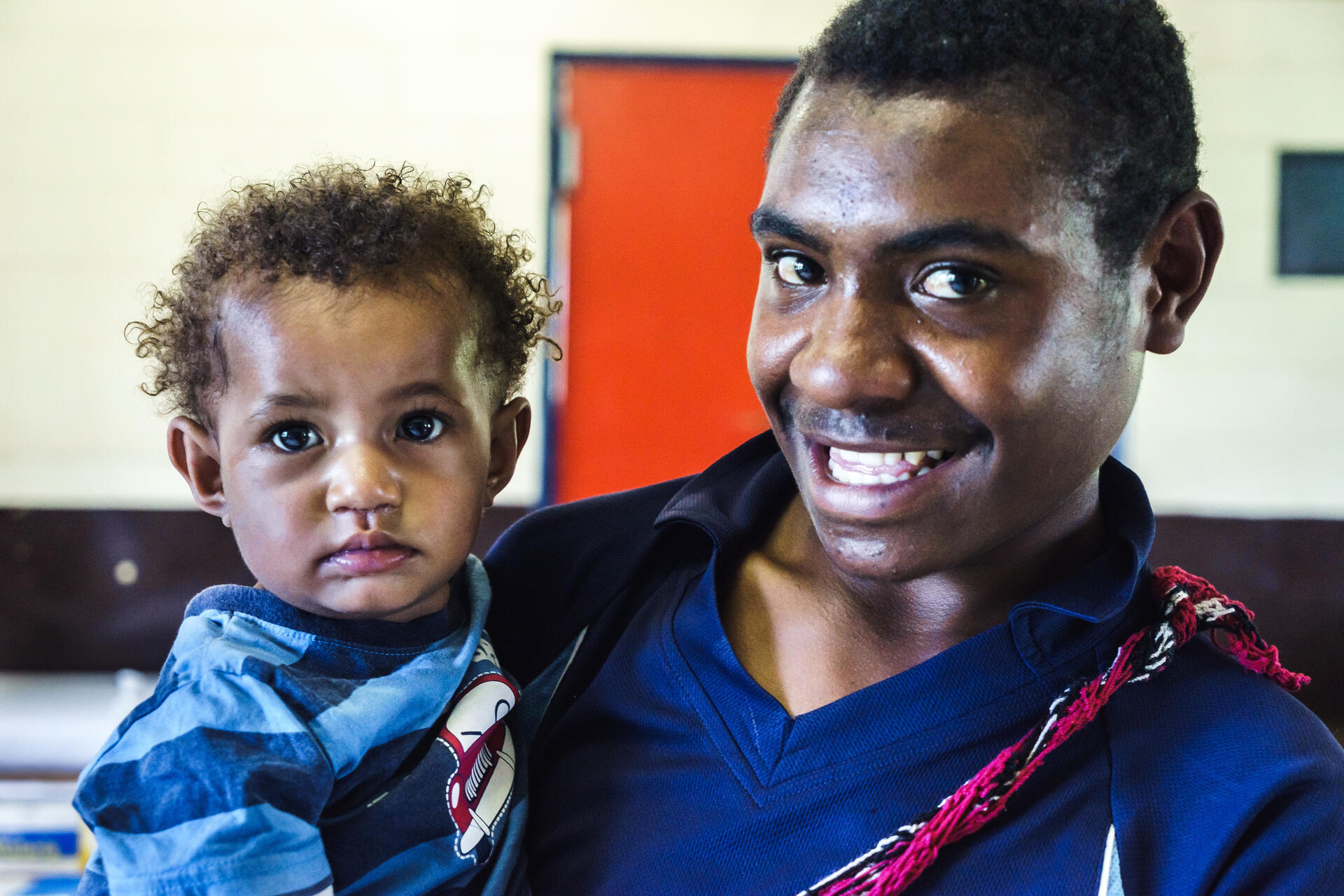 A photo of a father and child attending a medical appointment at the Goroka hospital in Papua New Guinea