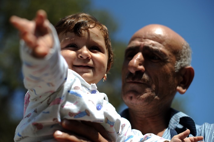 Rustam holds his grand daughter Madina, Central Europe Rustam holds his grand daughter Madina, Central Europe