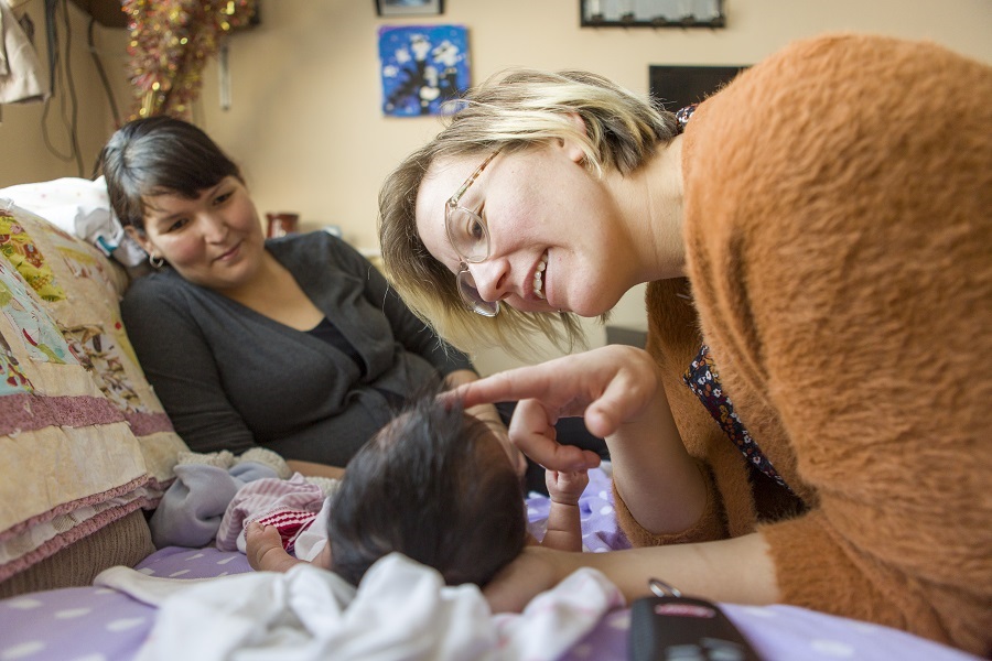 Midwife examines baby_Credit_WHO_Christine MCNAB-2