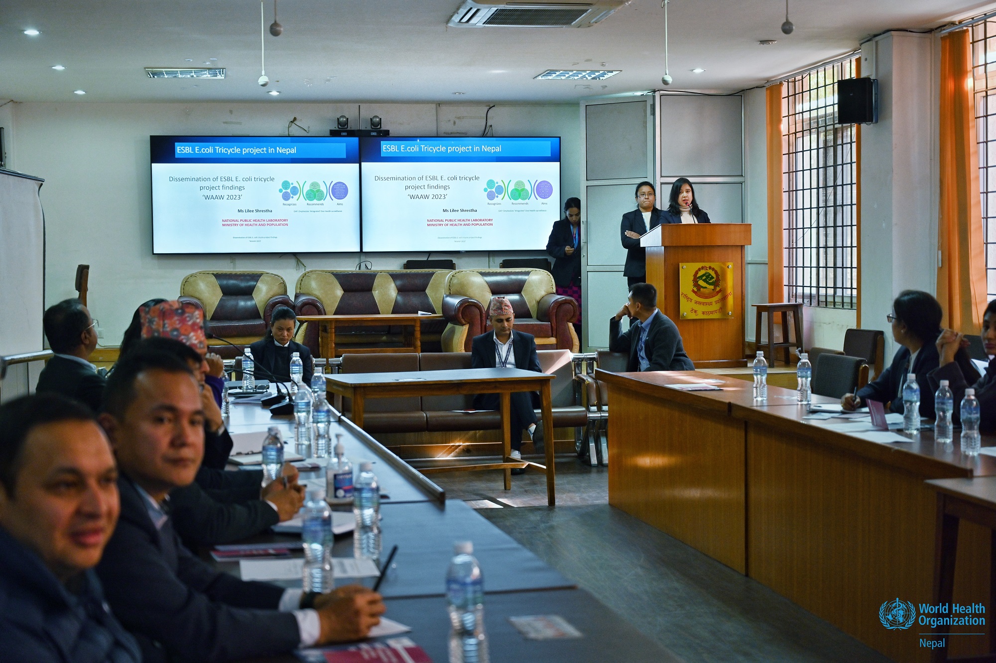 Ms Lilee Shrestha, Chief Medical Technologist, on a podium, presenting the findings of the Tricycle Project during a dissemination program held at the National Public Health Laboratory, Bagmati Province, Nepal