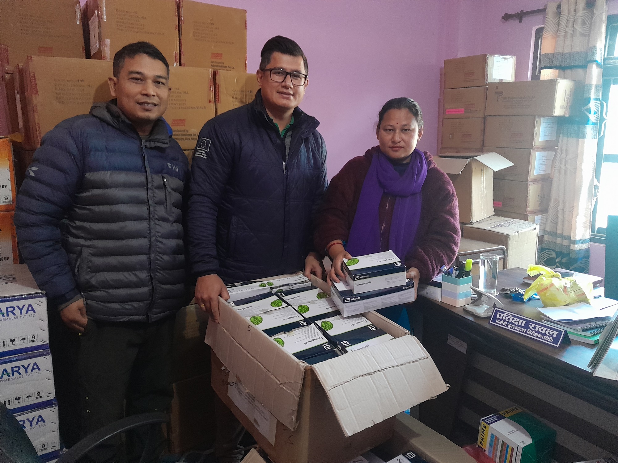 An image of WHO, Country Office for Nepal, handing over 1500 RDT dengue and scrub typhus kits each to a representative from the Provincial Health Logistics Management Center in earthquake-affected Karnali province, Nepal