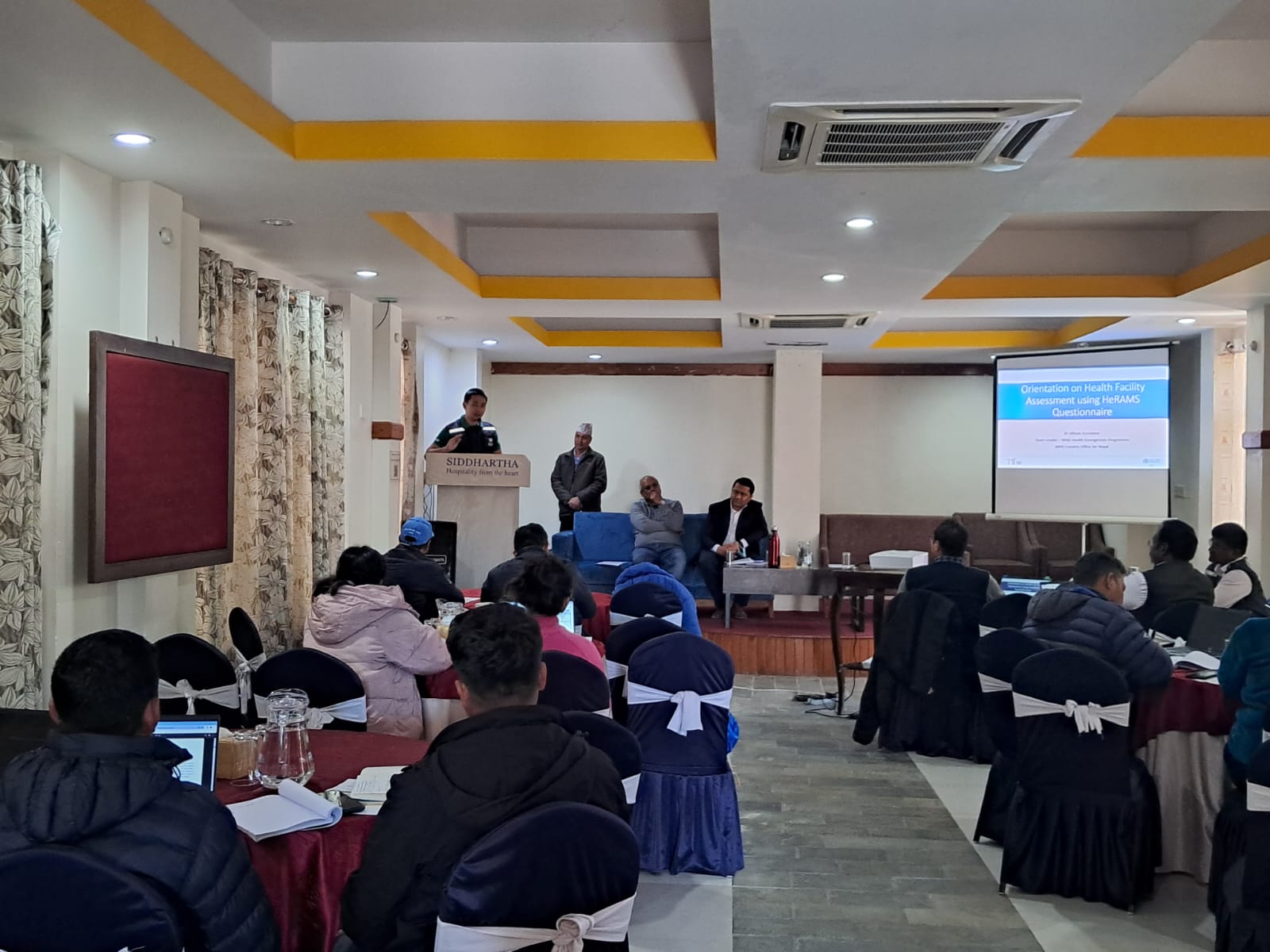 Dr Allison Gocotano (on the podium), Team Lead for WHO Health Emergencies Team, WHO Nepal, providing his remarks at the Health Resources and Services Availability Monitoring System (HeRAMS) orientation held in Karnali Province, Nepal