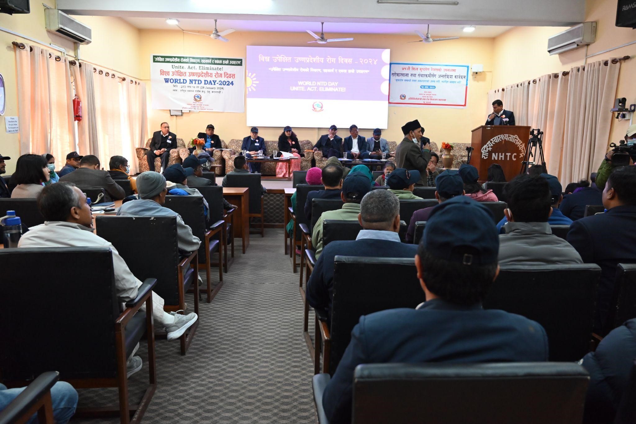 A wide shot of the participants and the honorable guests on the dias during the commemoration of the 5th Neglected Tropical Disease Day and 71st World Leprosy Day in Bagmati Province, Nepal