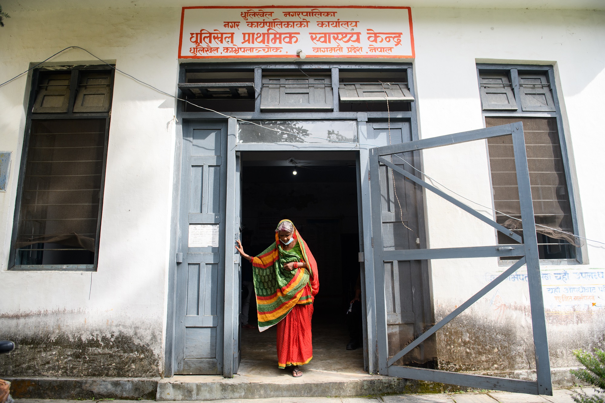 A drug-resistant tuberculosis (TB) patient leaving a TB health center after receiving medication in Bagmati Province, Nepal
