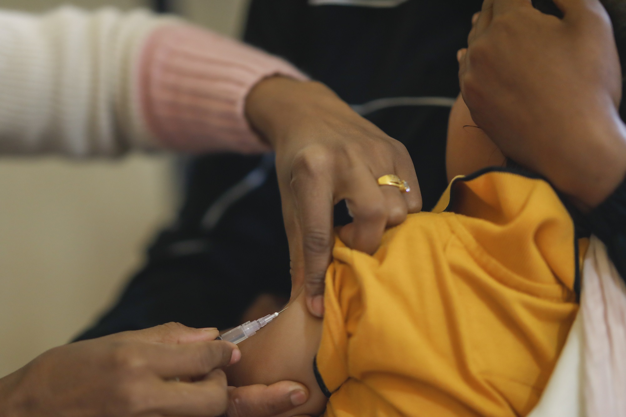 A health worker vaccinates a baby with the measles-rubella vaccine at a primary health center in Surkhet, Karnali Province, Nepal
