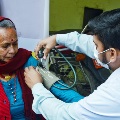 AnelderlyserviceseekergettingherbloodpressurecheckedinBagmatiProvinceNepal