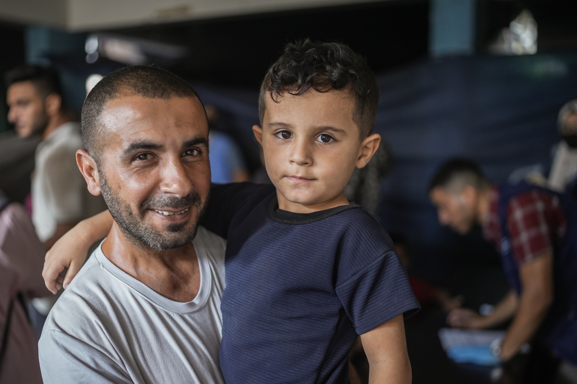 WHE 2025 Appeal Impact in 2024 occupied Palestinian territory A man is holding a young boy in his arms.