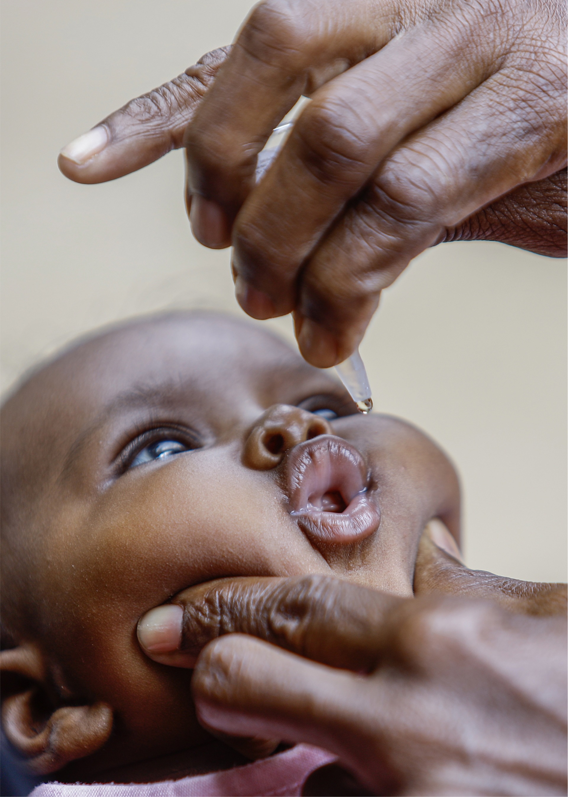 A baby is receiving oral polio vaccine.