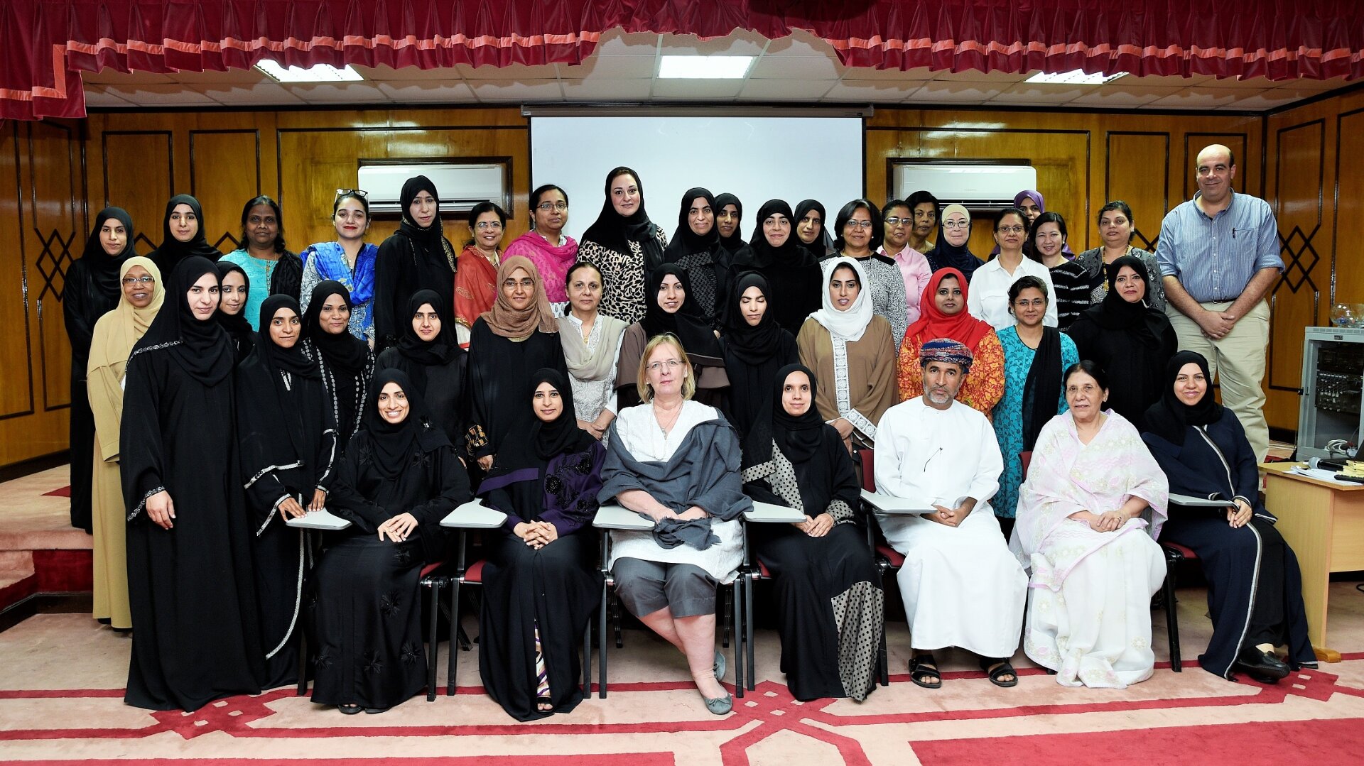 People in a room posing for a group photo.