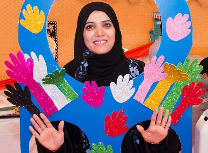 Dr Al-Maani in a photo booth promoting hand hygiene.