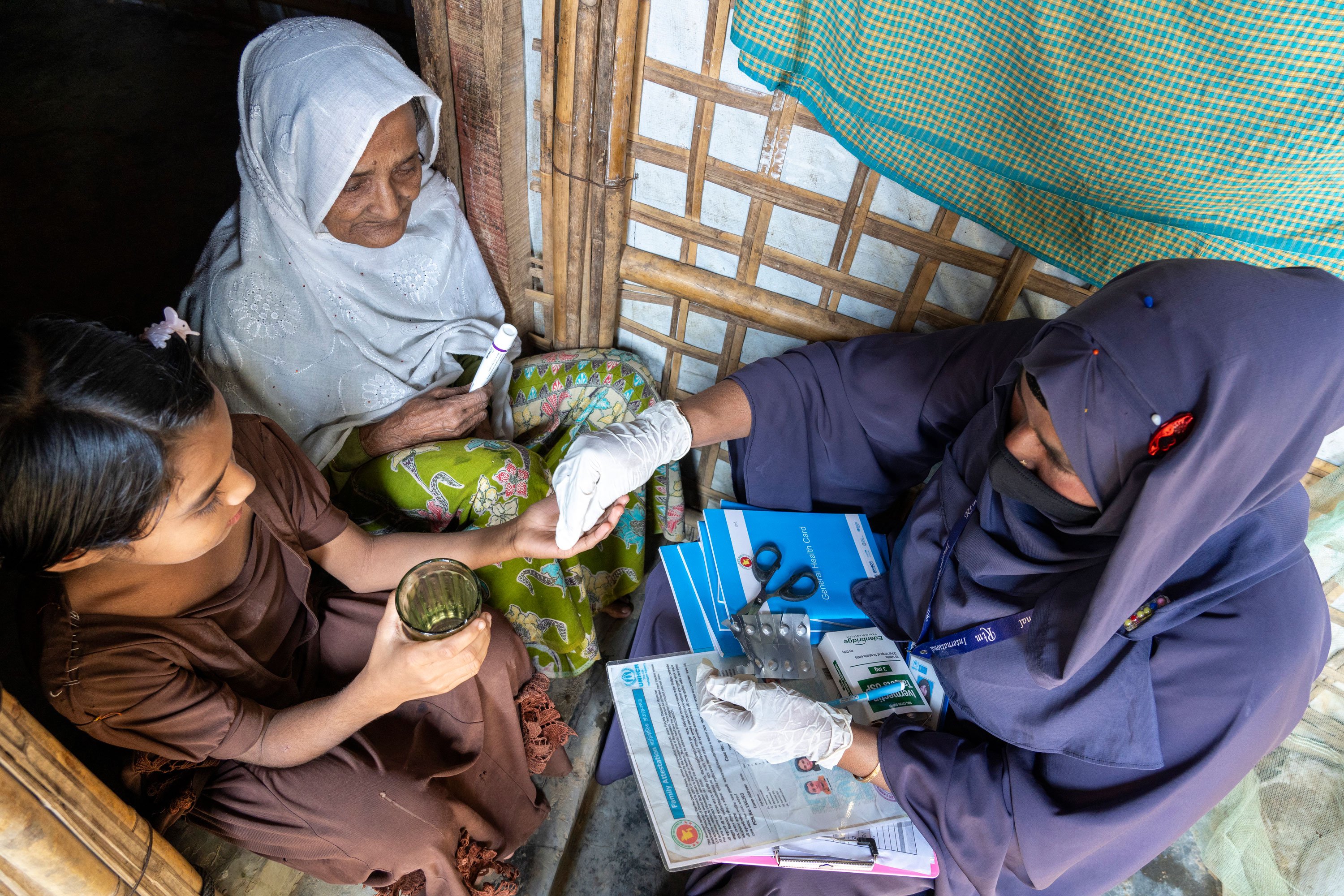 A community health worker administers ivermectin during the MDA campaign