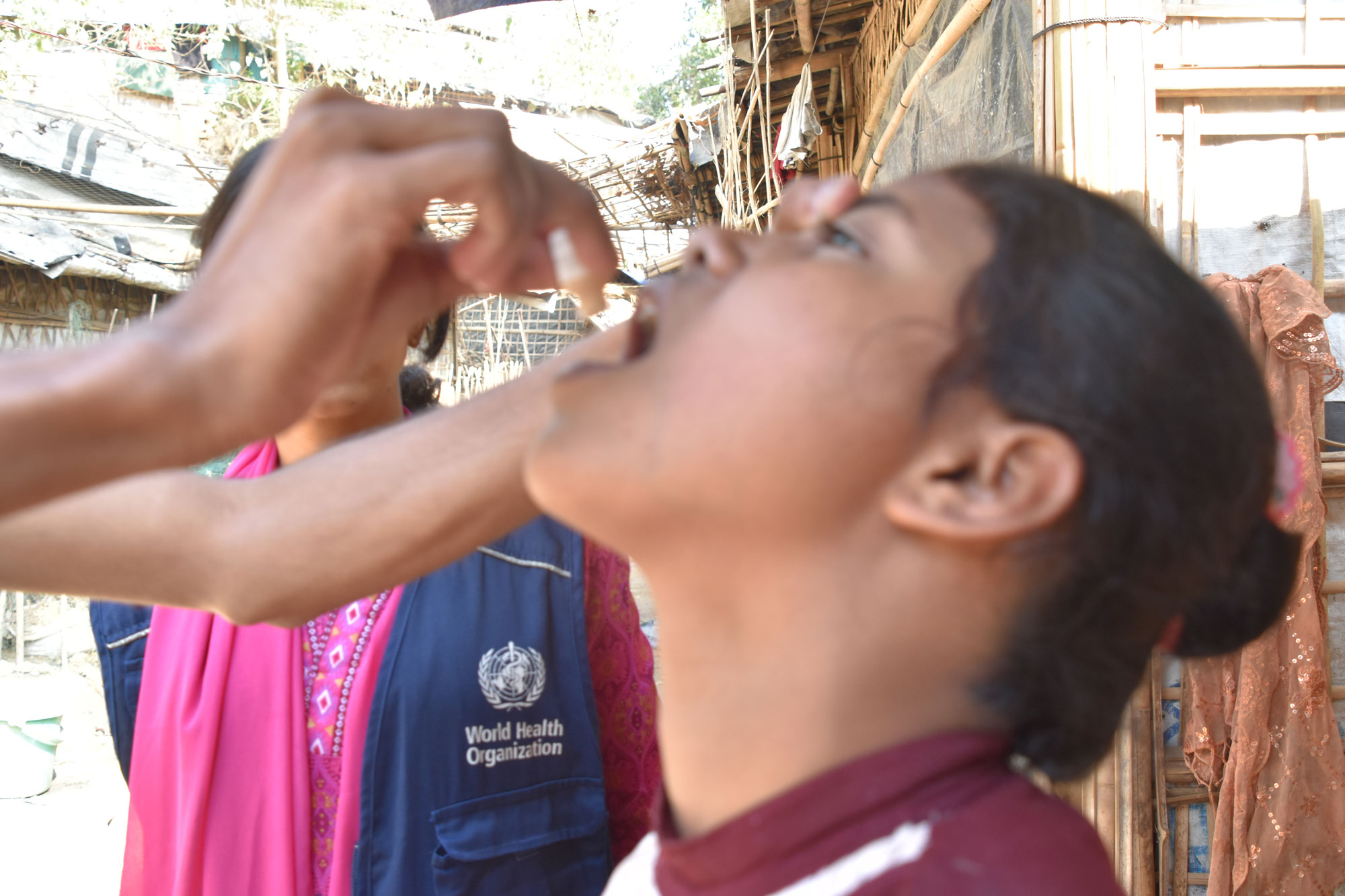 A young girl receives the OCV vaccine