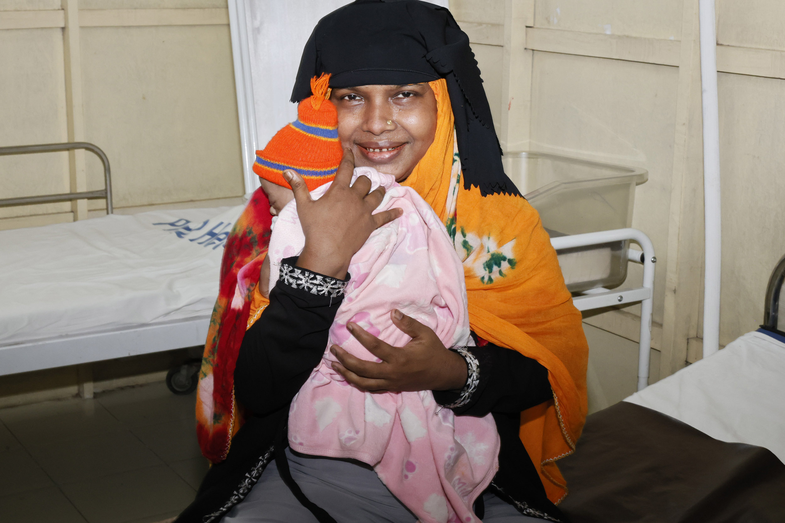 Ansar Begum holds her newborn baby