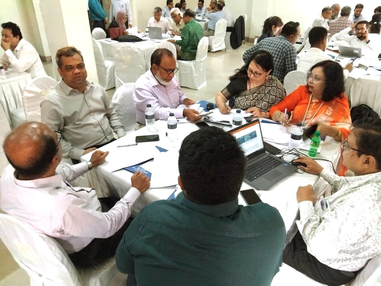 Clinicians and pharmacists review the draft of the National Essential Medicines List during a group discussion at the workshop.