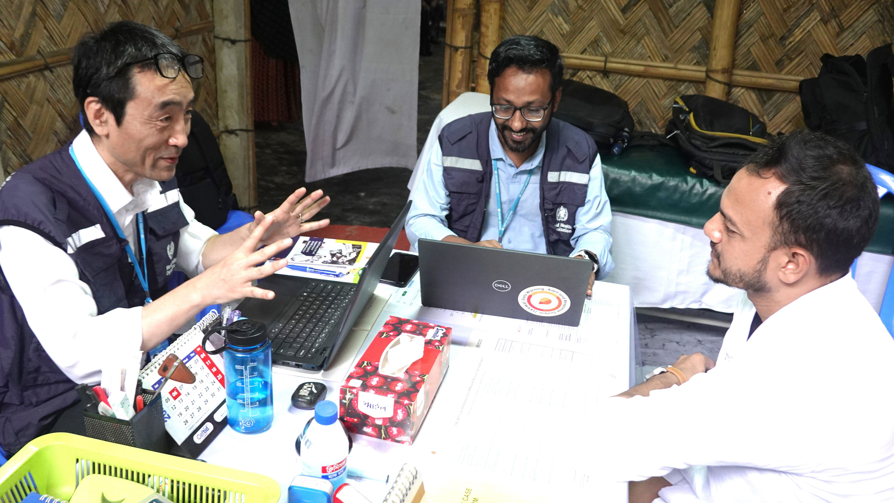Dr Masaya Kato speaks with a frontline healthcare provider during a field visit to Rohingya refugee camps in Cox’s Bazar, Bangladesh.