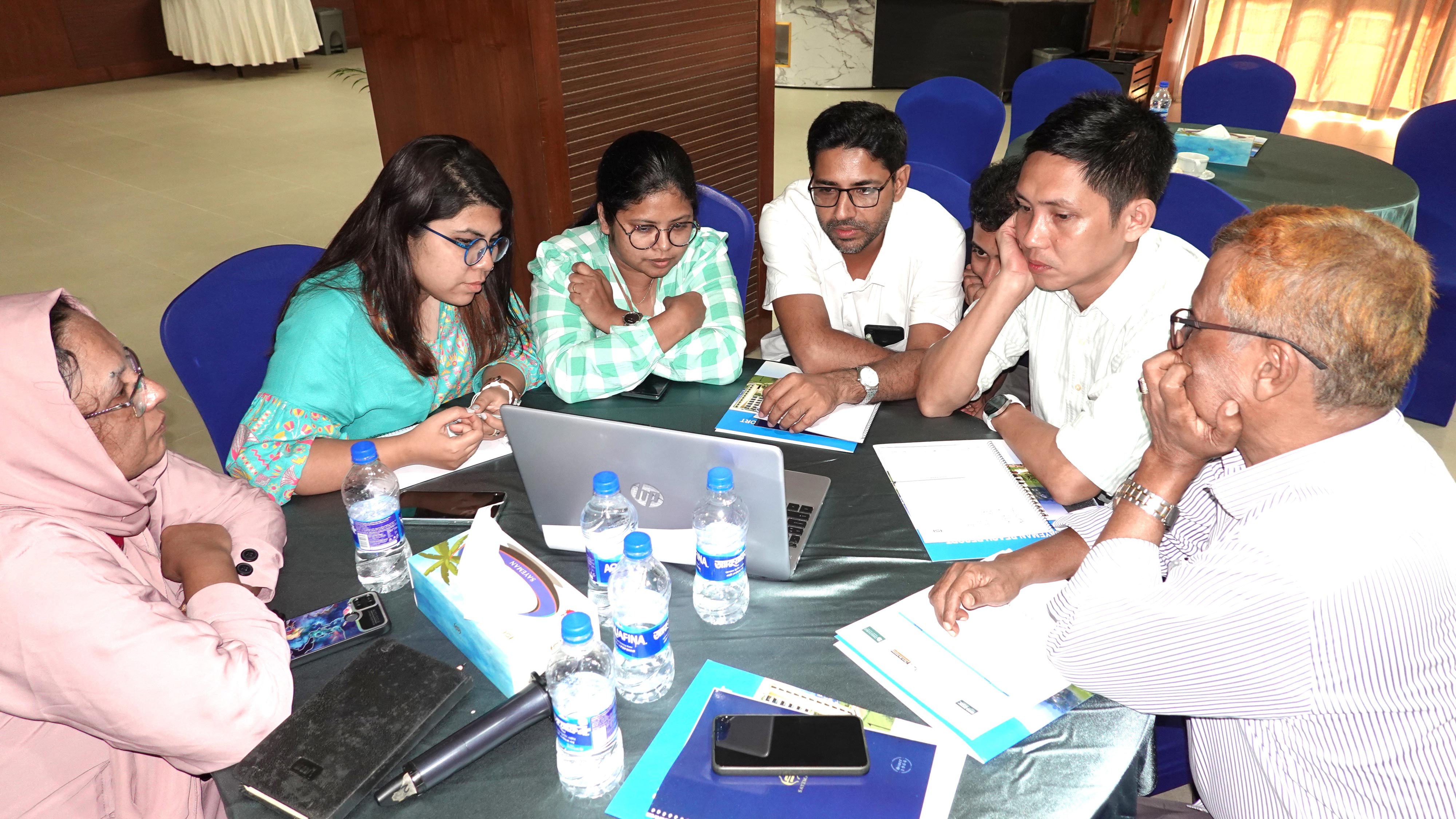 Participants collaborate in groups to brainstorm ways to mitigate PSEA risks for beneficiaries in Rohingya camps, Bangladesh.