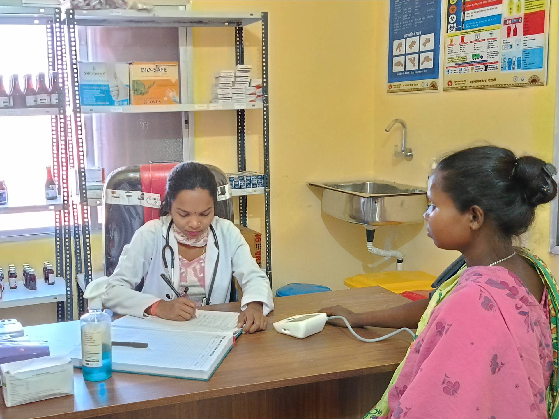 A community health officer Ms Ritu Kunjam screening Ms Kosi Markam for hypertension at Health Sub Centre Potali in Kuakonda block