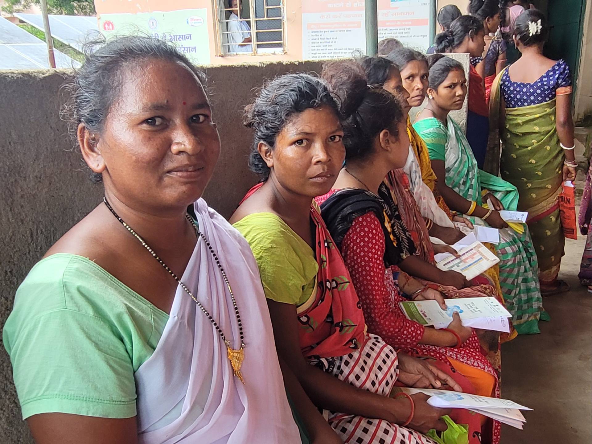 An ASHA (community health volunteer) accompanying pregnant women for their antenatal checkup at Community Health Centre in Tonto block