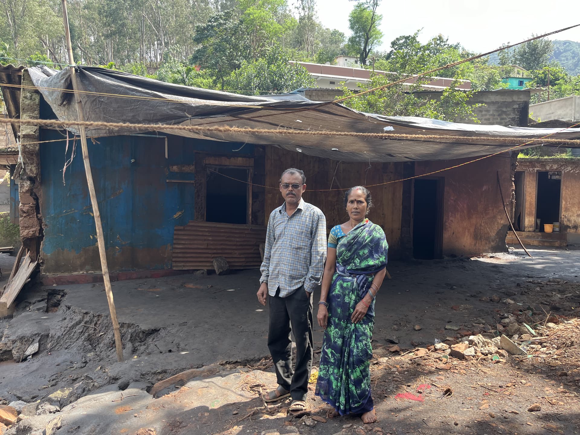 Mr Vinod Prasad Singh and Ms Geeta Singh outside their flood-damaged home in Kirandul
