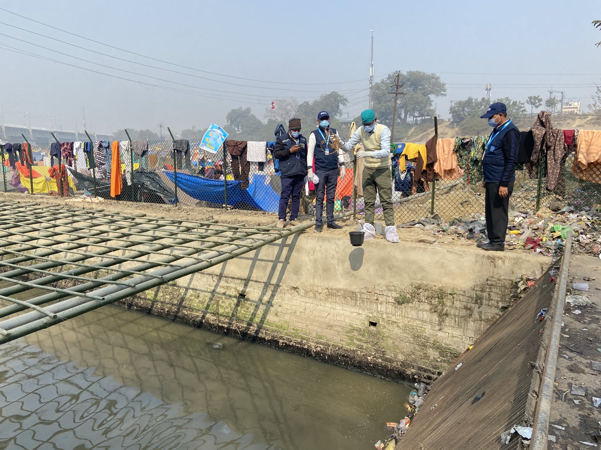 A group of people collecting sewage samples at Mori Pumping Station