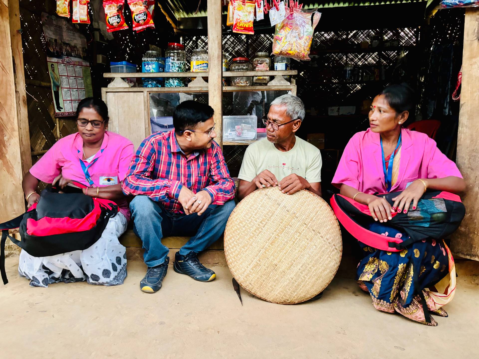 Mr Moni Ram Ingti weaving a basket wearing brand new spectacles provided to him a week ago by Accredited Social Eye Care Activists