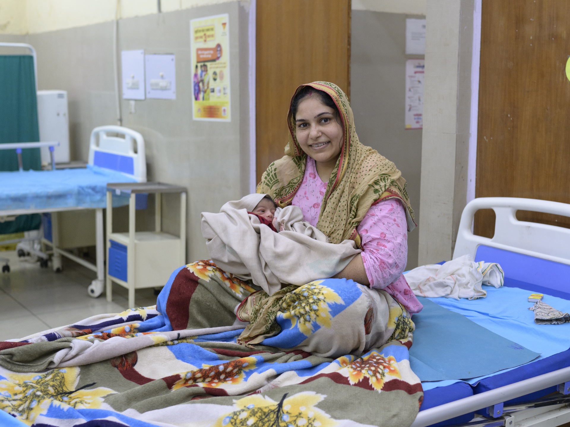 New mother Mrs Pooja holds her one-day-old son at the Maternity Home Yamuna Vihar, Delhi