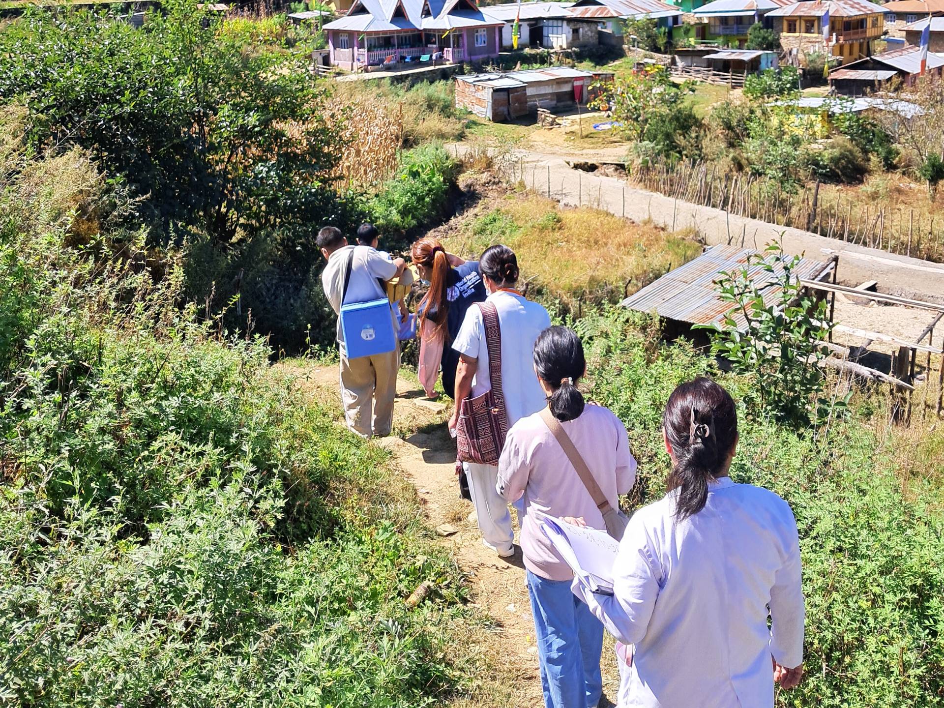 WHO field team and health workers at Community Health Centre Dirang in Kalapahar conducting a routine immunization session, counselling families, and addressing vaccine hesitancy.