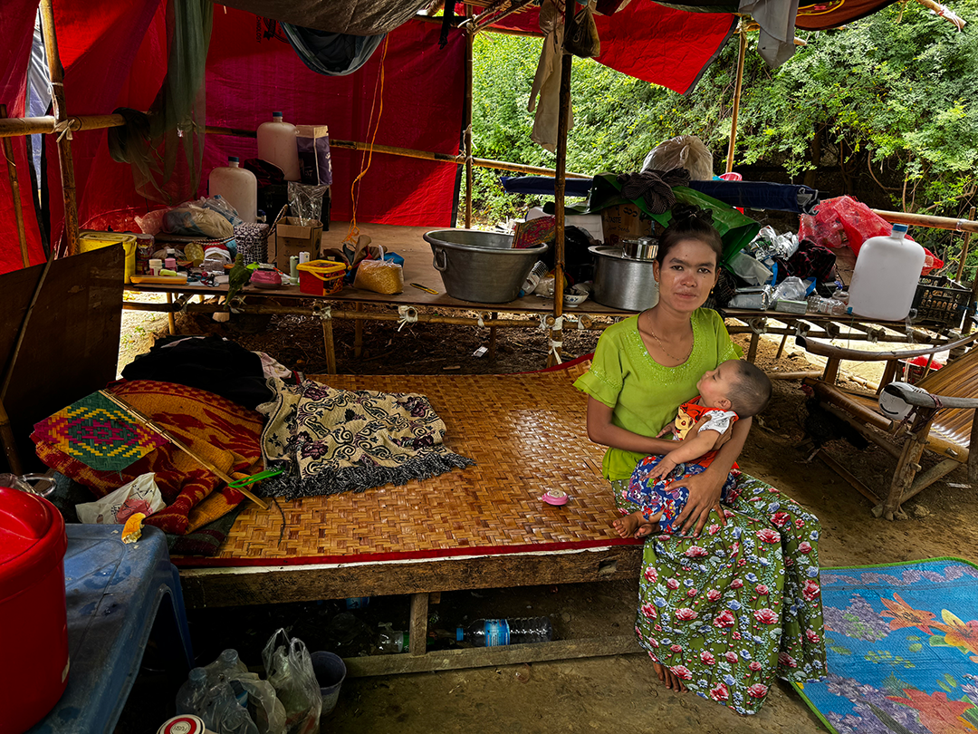 a mother of two and her baby, in their makeshift shelter from Mandalay earthquake relief camp