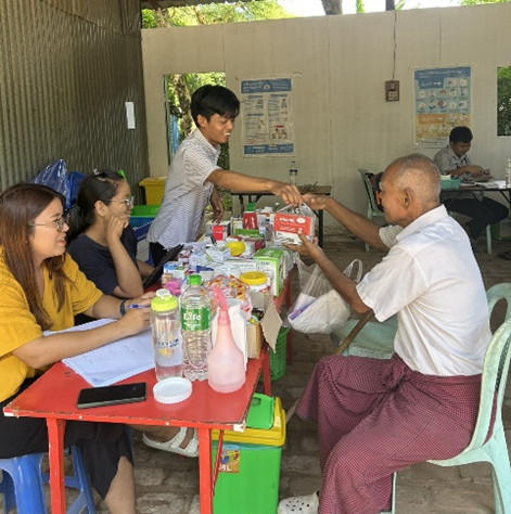 Receiving free essential health services at WHO health partner mobile clinic 3