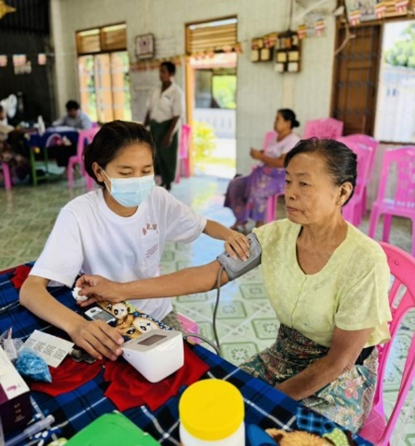 Receiving free essential health services at WHO health partner mobile clinic 5