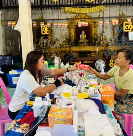 Receiving free essential health services at WHO health partner mobile clinic 6