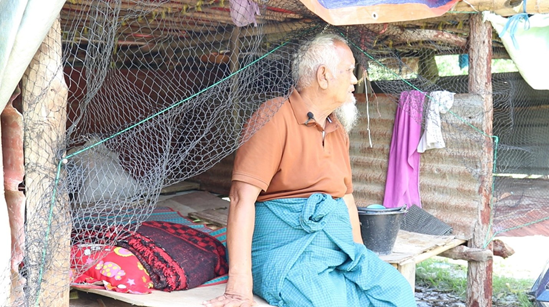 U Kyi (name changed) sitting in his tent in one of the Mandalay earthquake relief camps