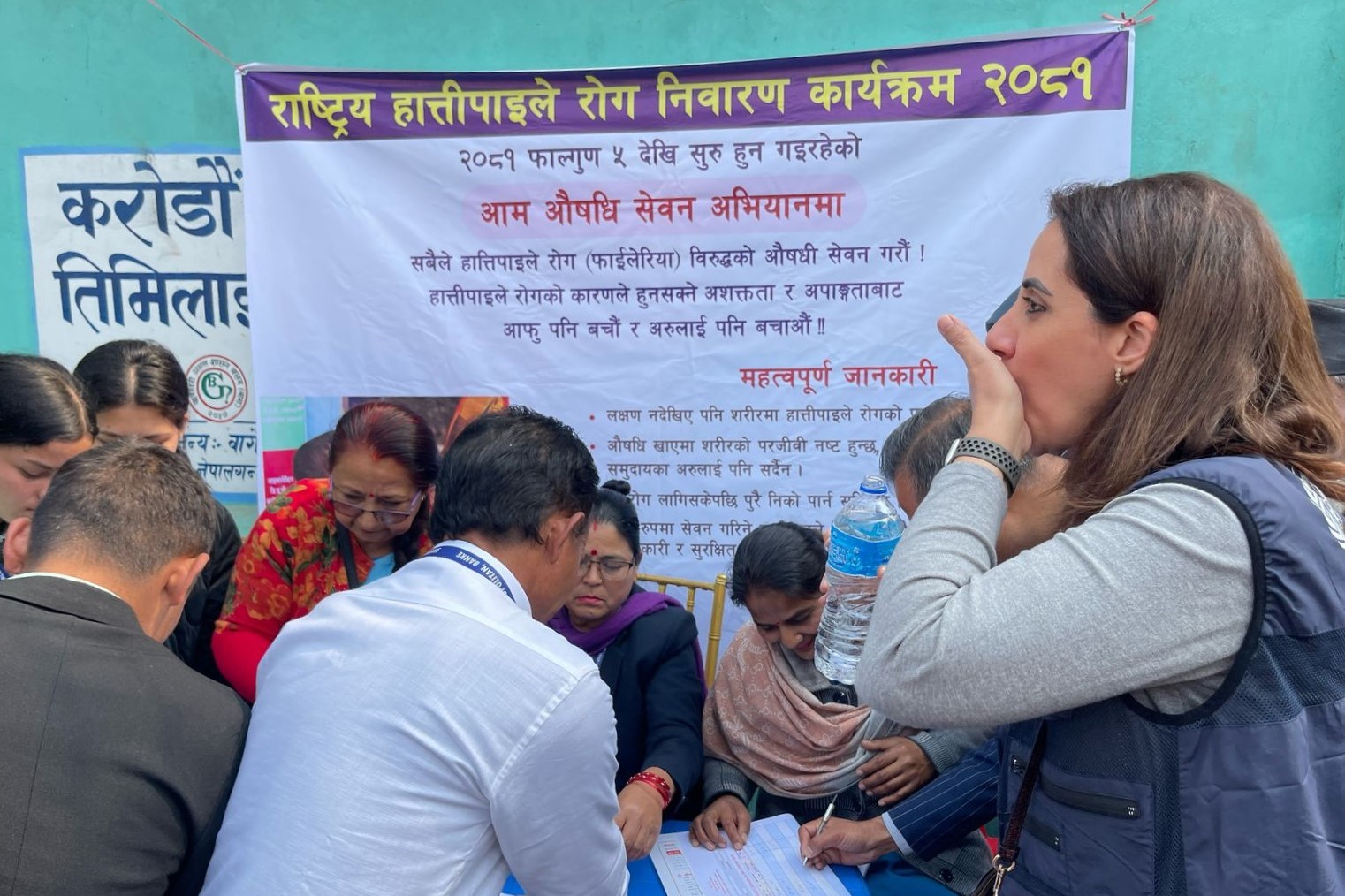 Dr Kenza Bennani, Team Lead for Communicable Diseases at the WHO Country Office for Nepal, taking part in the medication administration during the launch of the Mass Drug Administration campaign for lymphatic filariasis in Lumbini Province, Nepal