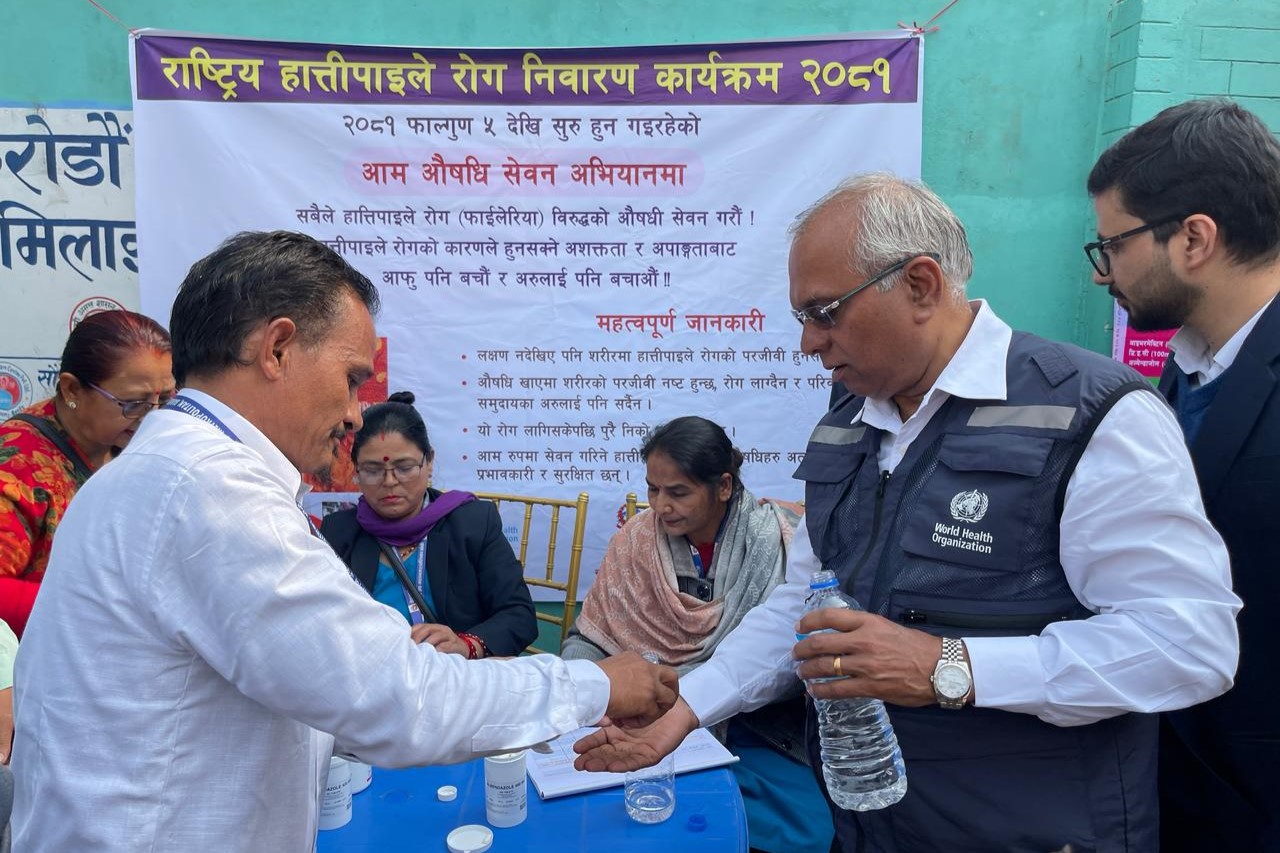 WHO Representative to Nepal participating in the administration of lymphatic filariasis medication during the launch of the Mass Drug Administration (MDA) campaign in Lumbini Province, Nepal