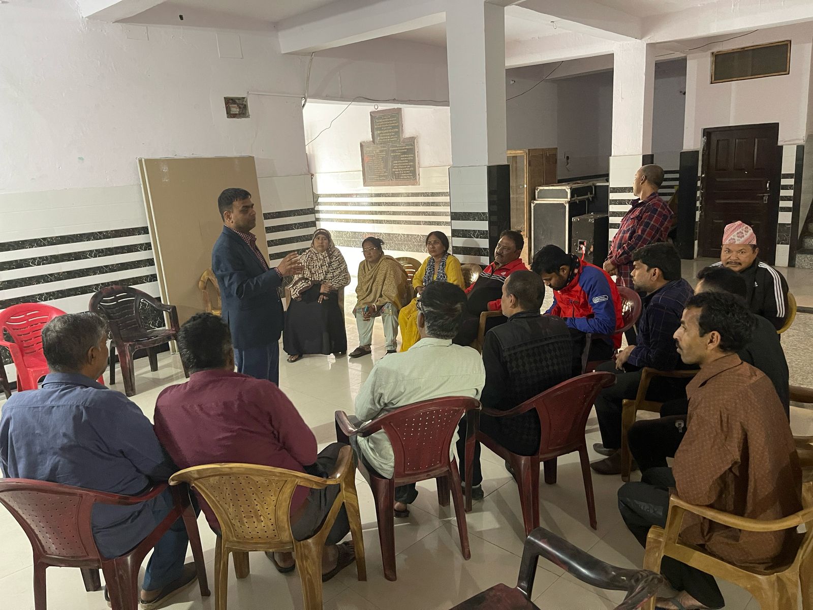 An official from Nepal's Epidemiology and Disease Control Division, Ministry of Health and Population, orients community leaders for their mobilization during the mass administration campaign against lymphatic filariasis in Banke district, Nepal