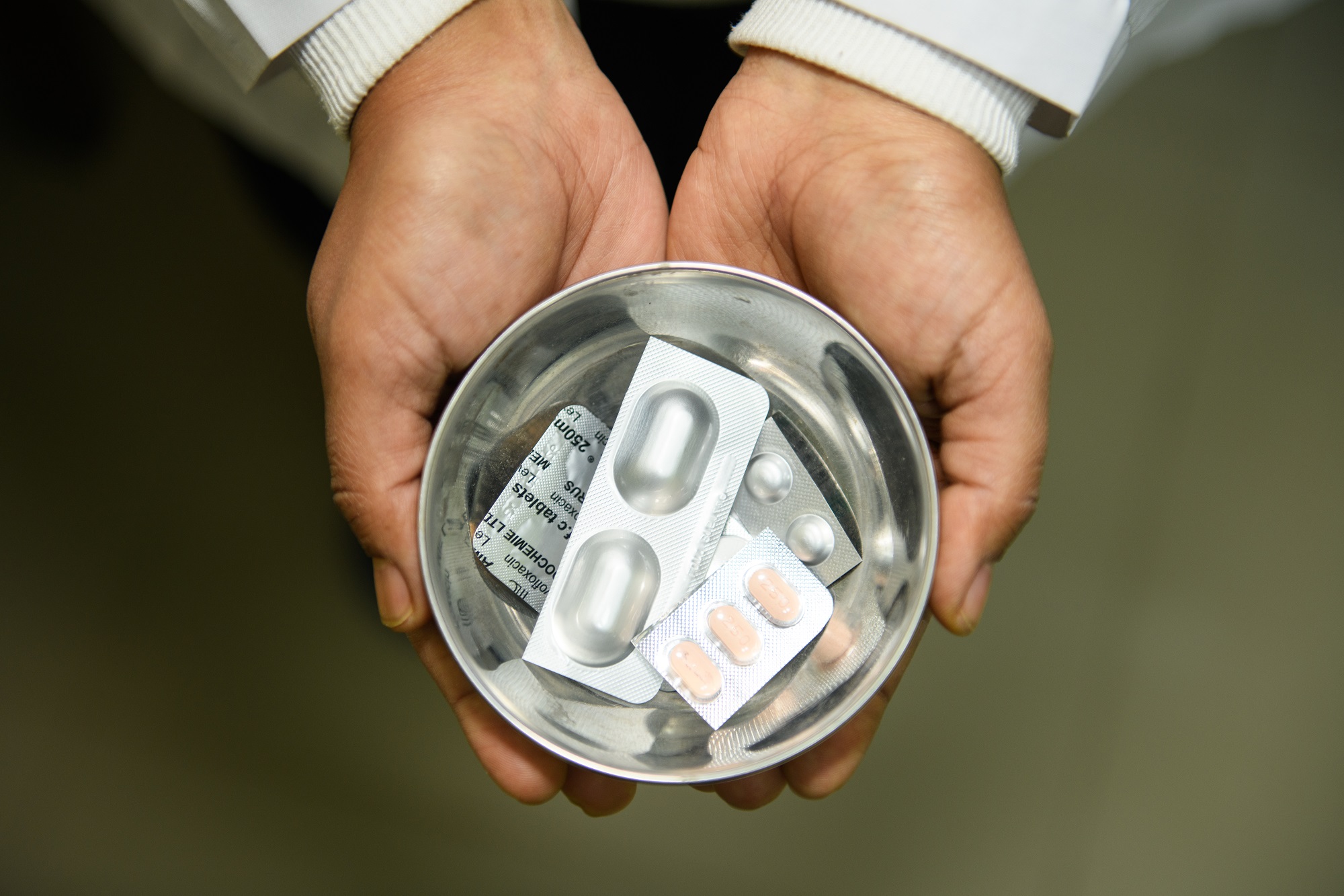 A health-care worker showcasing medications used for the treatment of multi-drug-resistant tuberculosis in Bagmati Province, Nepal