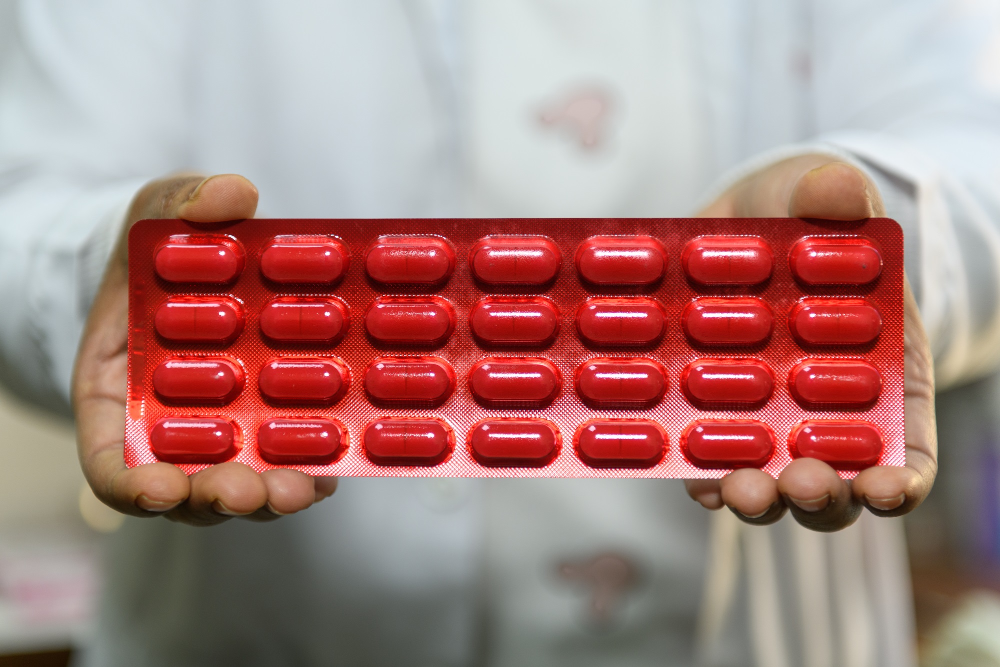 A health-care worker showcasing medications used for the treatment of multi-drug-resistant tuberculosis in Bagmati Province, Nepal