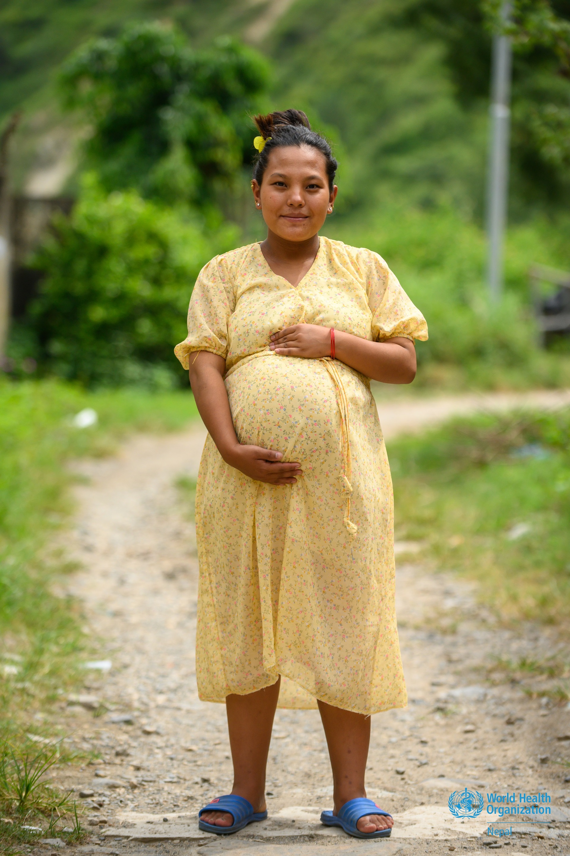 Illustration of a mother holding her baby, on a blue background with a world globe in pale blue, and the text "Communications Toolkit, World Health Day 2025".