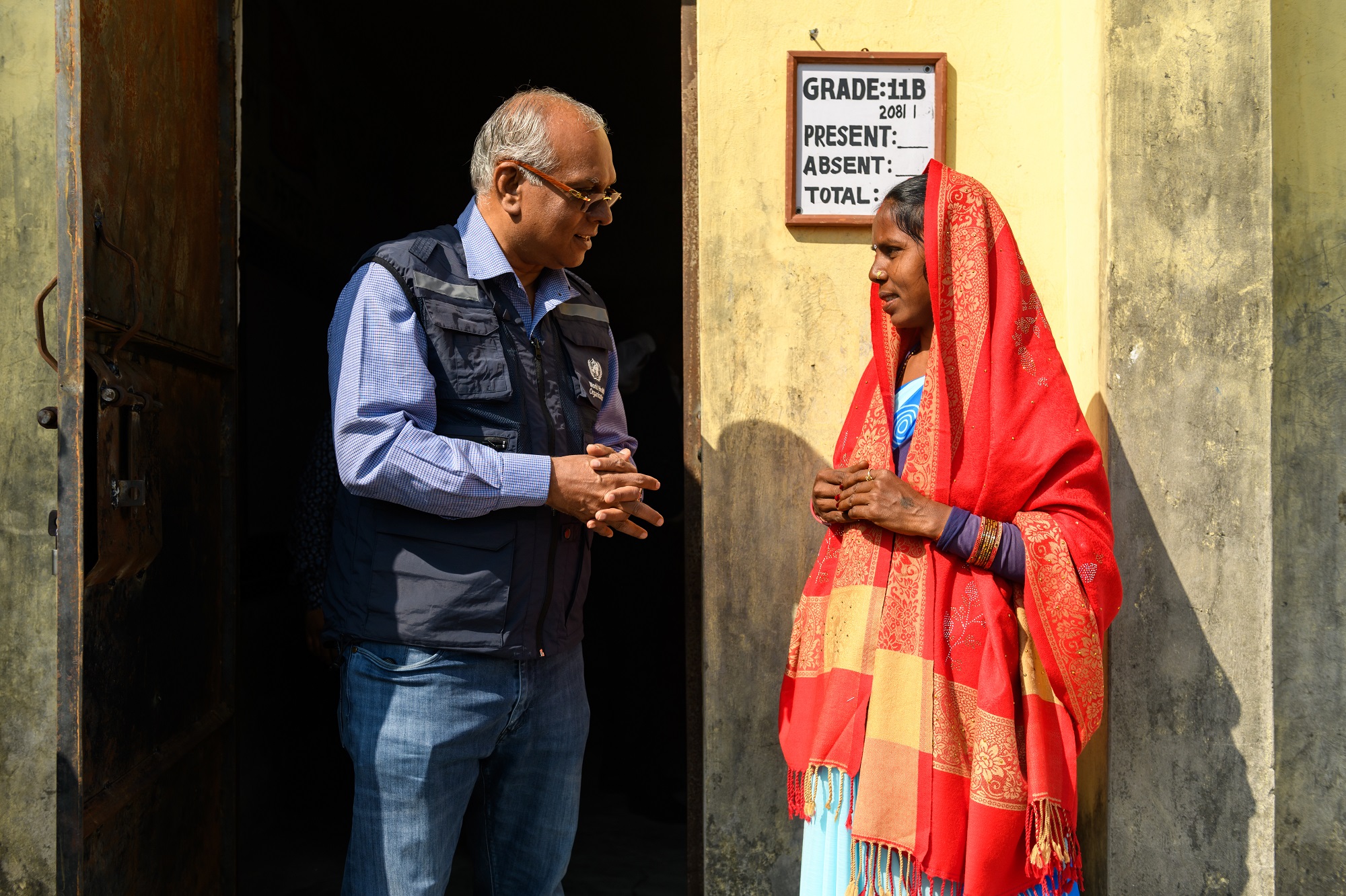 WHO Representative to Nepal (left) engages with a community member in Gandaki Province, Nepal, emphasizing the importance of the human papillomavirus (HPV) vaccine