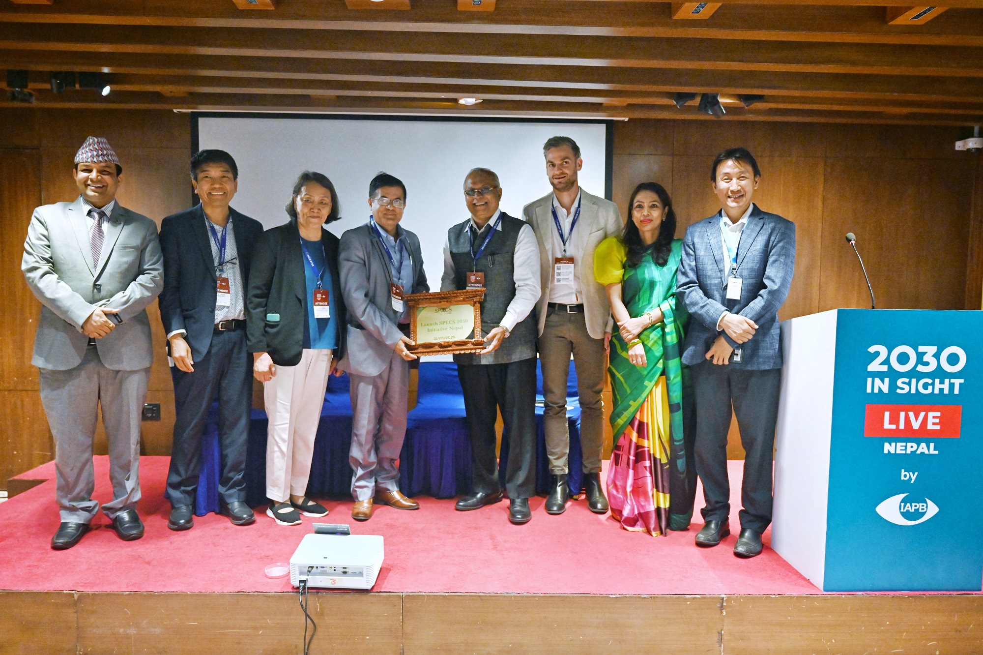 A ceremonial plaque presented by the WHO Representative to Nepal (right) to a dignitary from the Ministry of Health and Population during the launch of WHO SPECS 2030 in Nepal