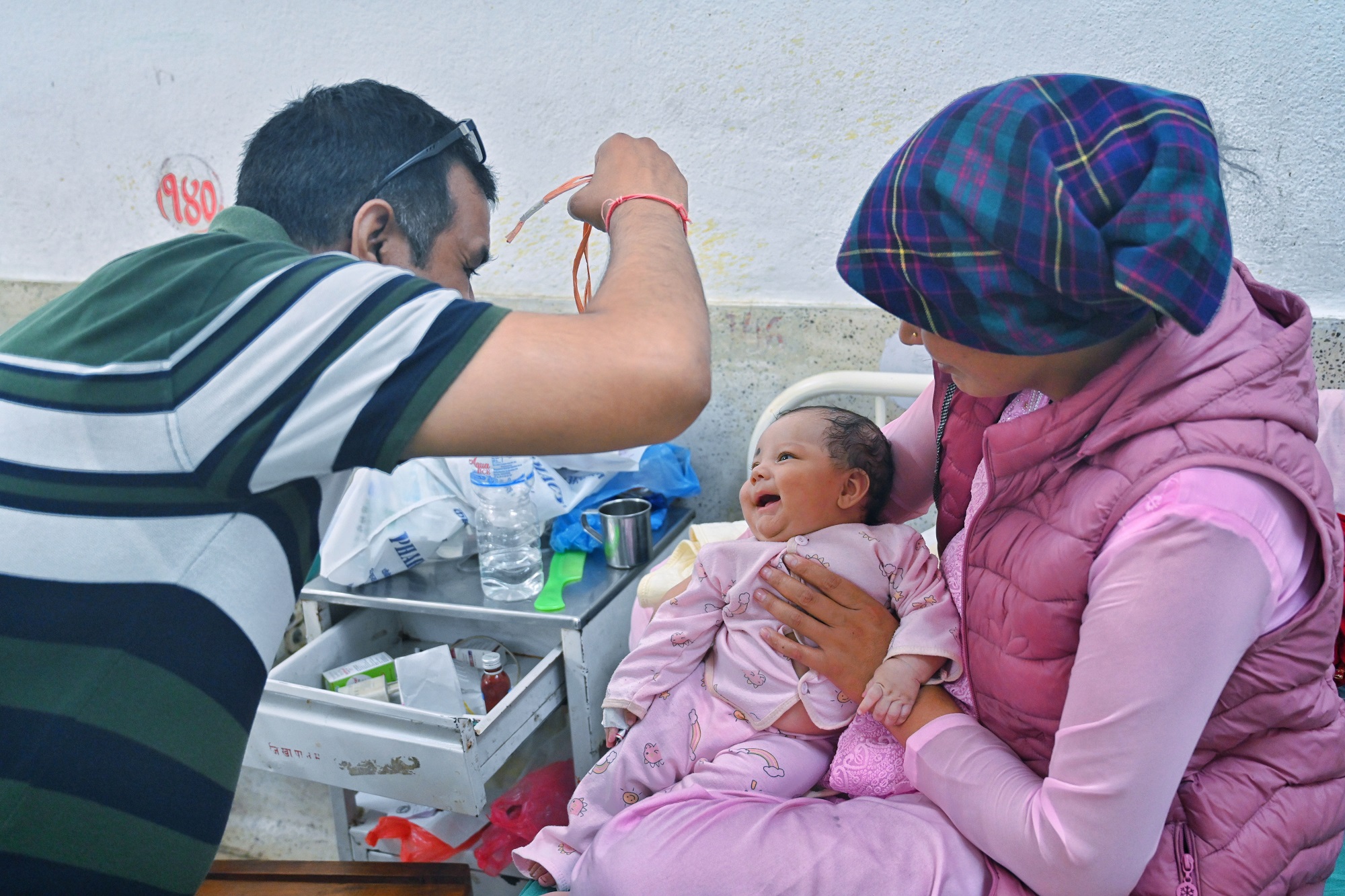 A participant (left) engages in developmentally appropriate play with a baby, as part of the Child Development Couse, at Kanti Children’s Hospital, Nepal.